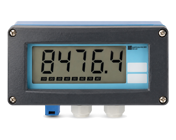 RIA261-ENDRESS-HAUSER — DERAAK Digital panel meter showing 8476.4 on an LCD, blue housing with two white buttons on the right and blue and white cable fittings at the bottom.