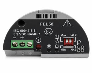 Electrical control module with two green terminal screws, a red indicator light, and a right-side adjustable setting dial.] , but this seems off; I will correct it.