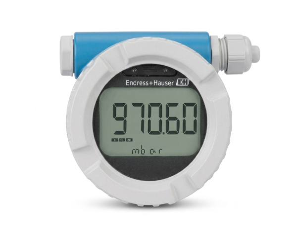 Endress+Hauser flow meter with a white circular body and blue top; LCD displays 970.60