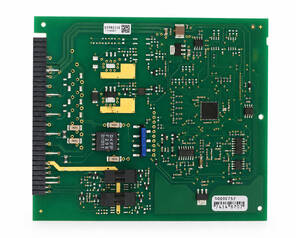 Green printed circuit board with numerous surface-mount components and a left-edge connector, photographed top-down.