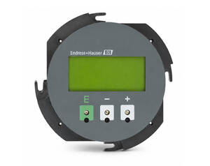 Circular Endress+Hauser panel meter with a green LCD screen and three labeled buttons (E, −, +) on a dark mounting ring; used to display measurements.