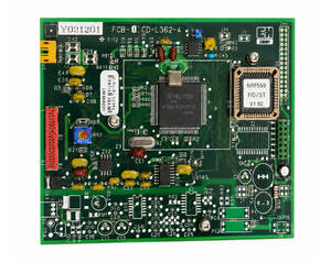 Green PCB populated with IC at center, edge connectors, yellow capacitors, and various chips and components visible.