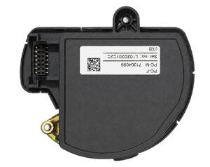 Circular TPMS sensor module with an electrical connector on the left, a mounting tab on top, and a label on its body.